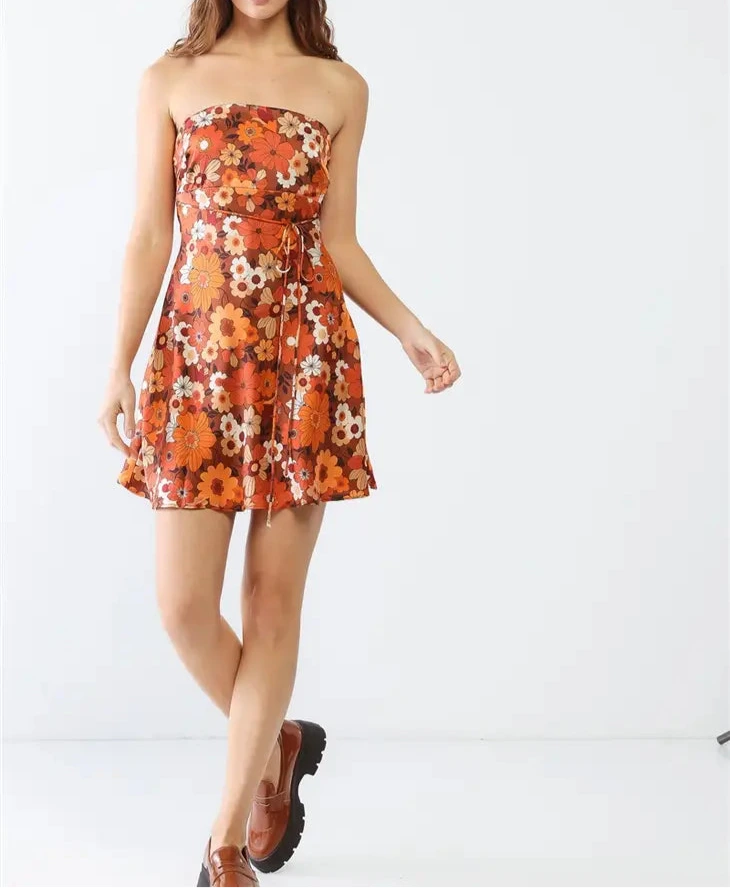 Woman wearing a strapless floral dress on a white background
